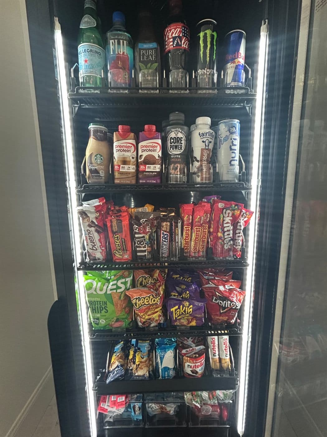 Client-supplied glass-door smart machine stocked with beverages and snacks